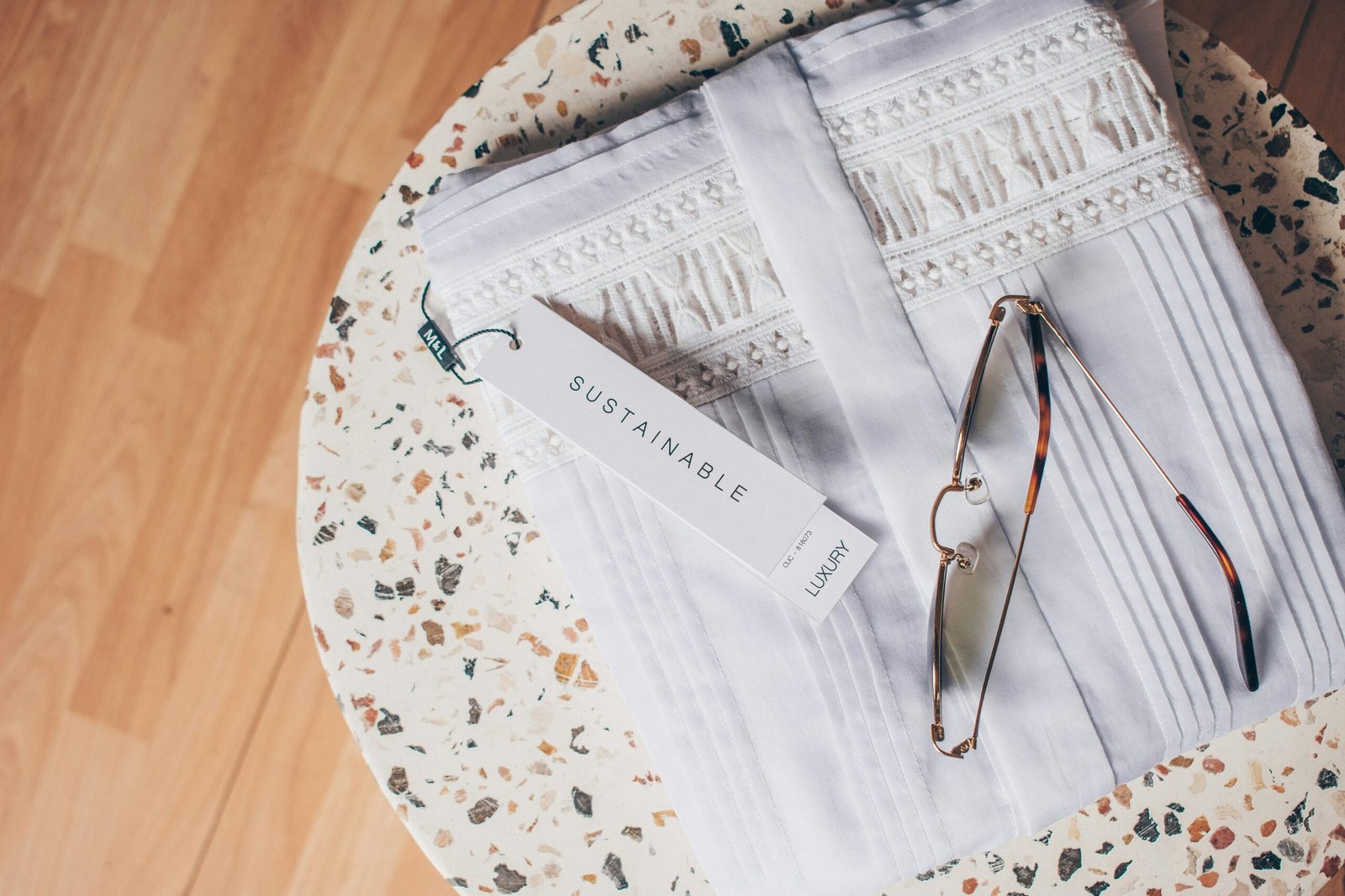 silver framed eyeglasses on white and blue floral textile